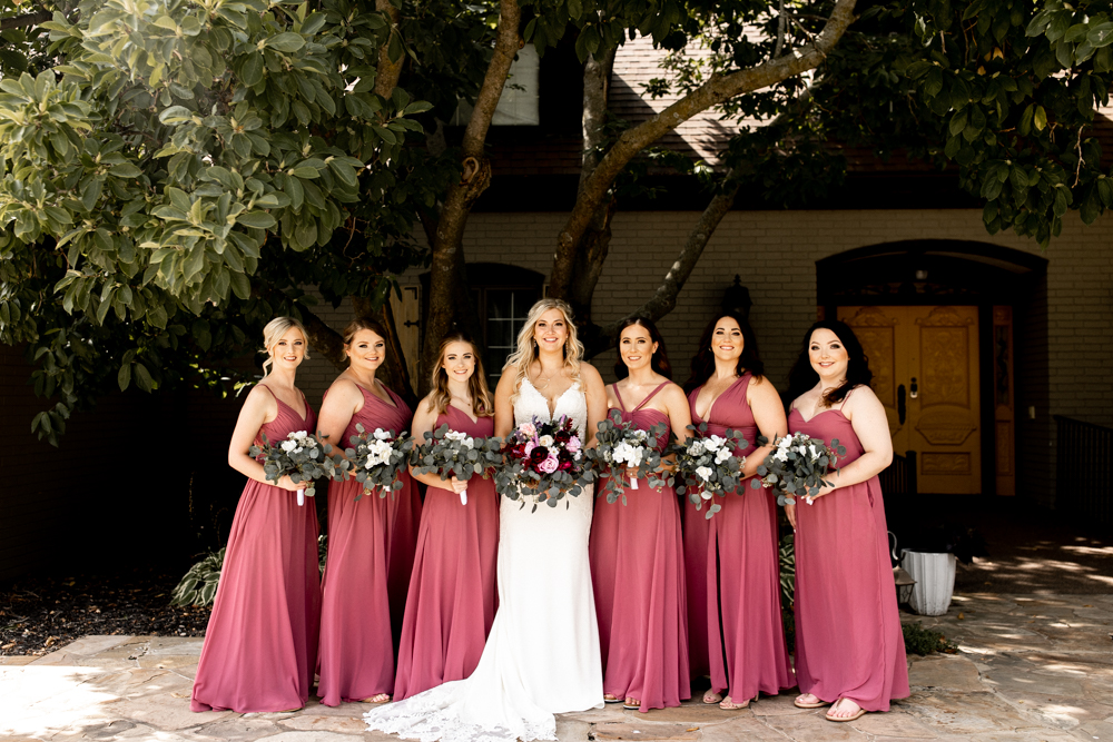 Beautiful bridesmaid dresses in shade of pink with gorgeous floral bouquets to compliment the colors. 