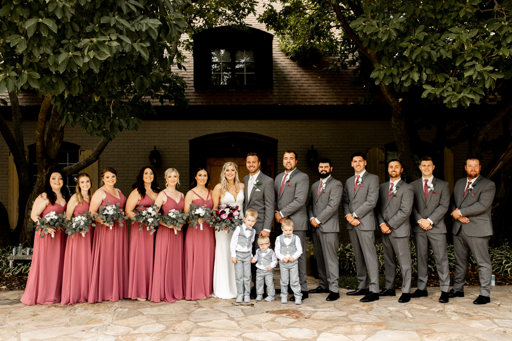 Entire wedding party in front of Conrad Mansion
