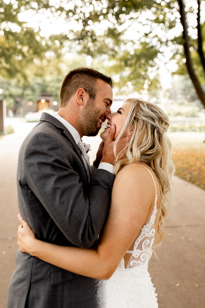 Husband and wife are gleaming and flashing huge smiles as they stare into each others eyes and hold each other close following their romantic wedding at the Conrad Mansion in Iowa.