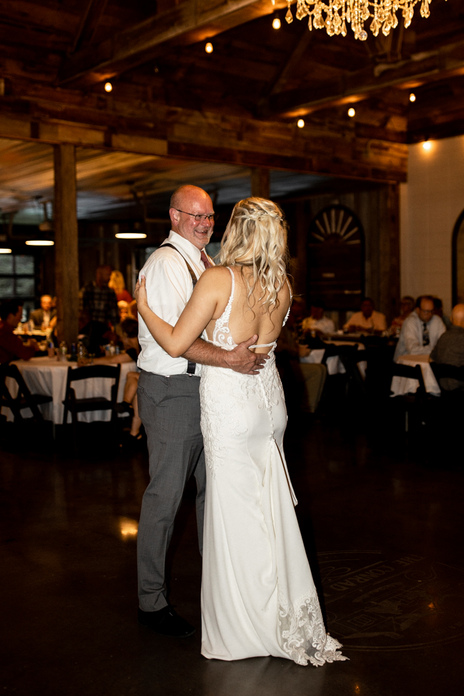 The bride and her dad share a dance at the beautiful wedding reception.