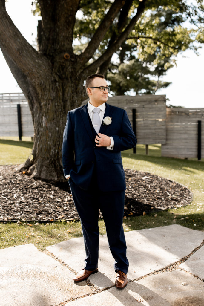 Groom poses for the wedding photographer. He is ready to see his bride on their wedding day!