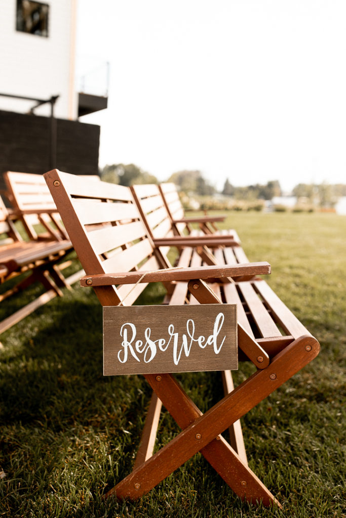 Outdoor fall Iowa wedding - Photo shows the wood seating and reserved sign for the family. 