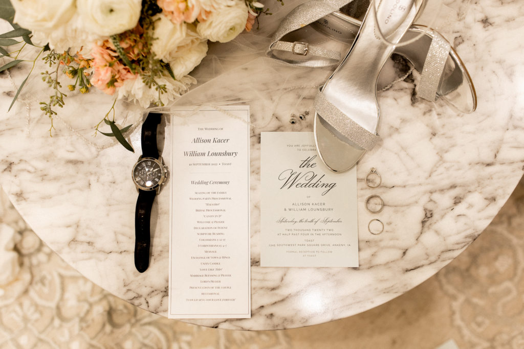 Gorgeous details photo of wedding invite and program, accessories, rings, shoes, and bridal bouquet. 