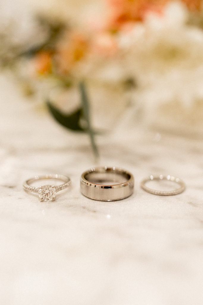 Close photo of bride and groom's beautiful engagement and wedding rings. 