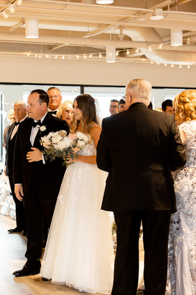 Dad and daughter come to the end of the aisle and dad offers the bride to the groom. Beautiful moments and memories of the wedding day captured by Iowa Wedding Photographer. 