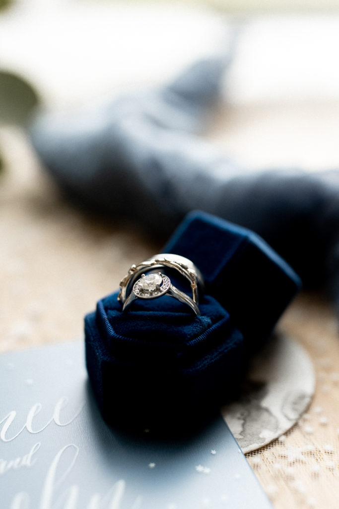 Blue velvet ring box holds both of the wedding rings of the bride and groom. 