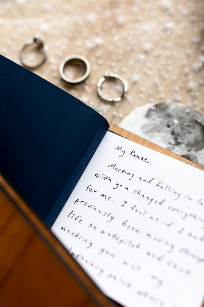 More details showing vows written from groom to bride and wedding and engagement rings. 