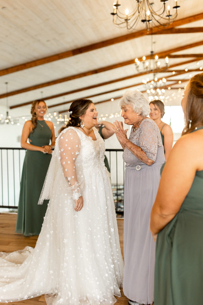 Bride and her grandma share joyful smiles after she sees the bride for the first time. Sweet and joyful moments before the wedding ceremony captured by DSM Iowa Wedding Photographer. 