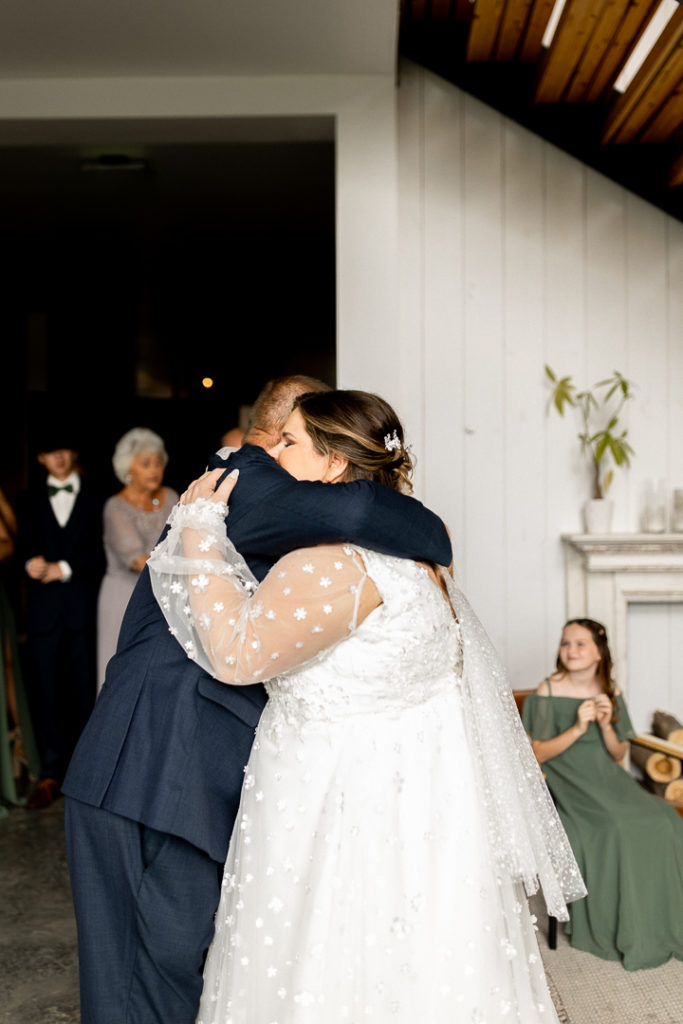 Bride and her dad share a big hug after their first look. Overhwhelmed with joy and emotion.