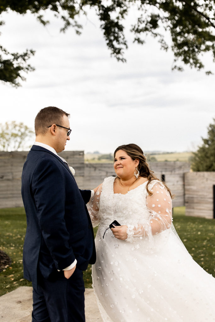 Groom turns around to see his bride for the first time on their wedding day. Captured by Iowa Wedding and Lifestyle Photographer. 